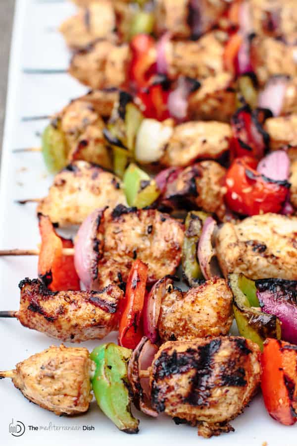 Mediterranean Grilled Chicken Kabobs Recipe + Cayenne Tahini Sauce! Make chicken kabobs like a Mediterranean pro! Marinated in Mediterranean spices with fresh garlic and lime juice, these kabobs are simply succulent! Try them for your next party with an easy tahini sauce!