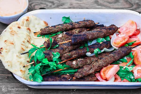 Kofta with a side of tomatoes, tahini and pita 