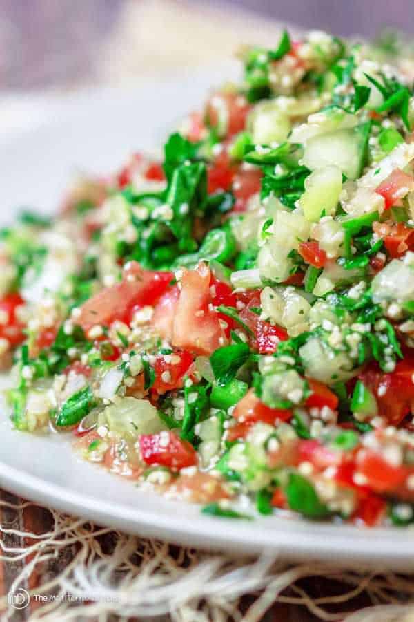 Tabouli Recipe | The Mediterranean Dish. Authentic Middle Eastern tabouli salad with fresh parsley, mint, bulgur, finely chopped vegetables and a simple citrus dressing. See the step-by-step tutorial at The Mediterranean Dish food blog.