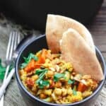 Turmeric Roasted Cauliflower and Chickpea Stew Recipe (tutorial)| The Mediterranean Dish. A delicious vegan, gluten free chickpea stew that is hearty, healthy and flavor-packed. Roasted cauliflower and carrots are added with chickpeas and spices in a chunky tomato sauce. Easy Mediterranean recipe with step-by-step tutorial from TheMediterraneanDish.com