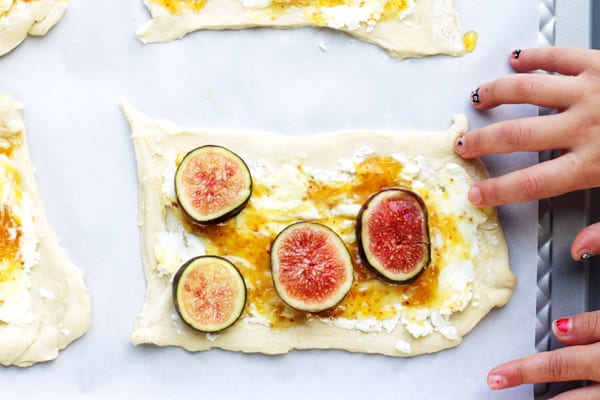 Raw dough with figs, jam and cheese on top