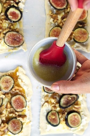 Brush immersed in bowl of melted butter