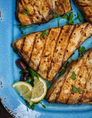 grilled sword fish with a side of limes