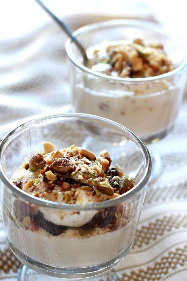 Two servings of Greek Yogurt Parfait garnished with crushed nuts