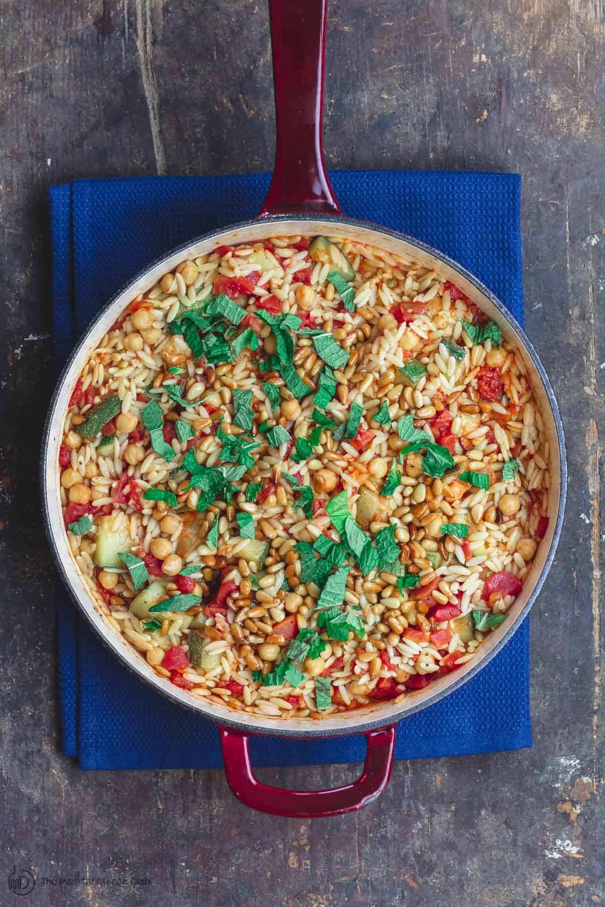 Orzo with zucchini, Chickpeas and Tomatoes. Garnished with mint and pine nuts