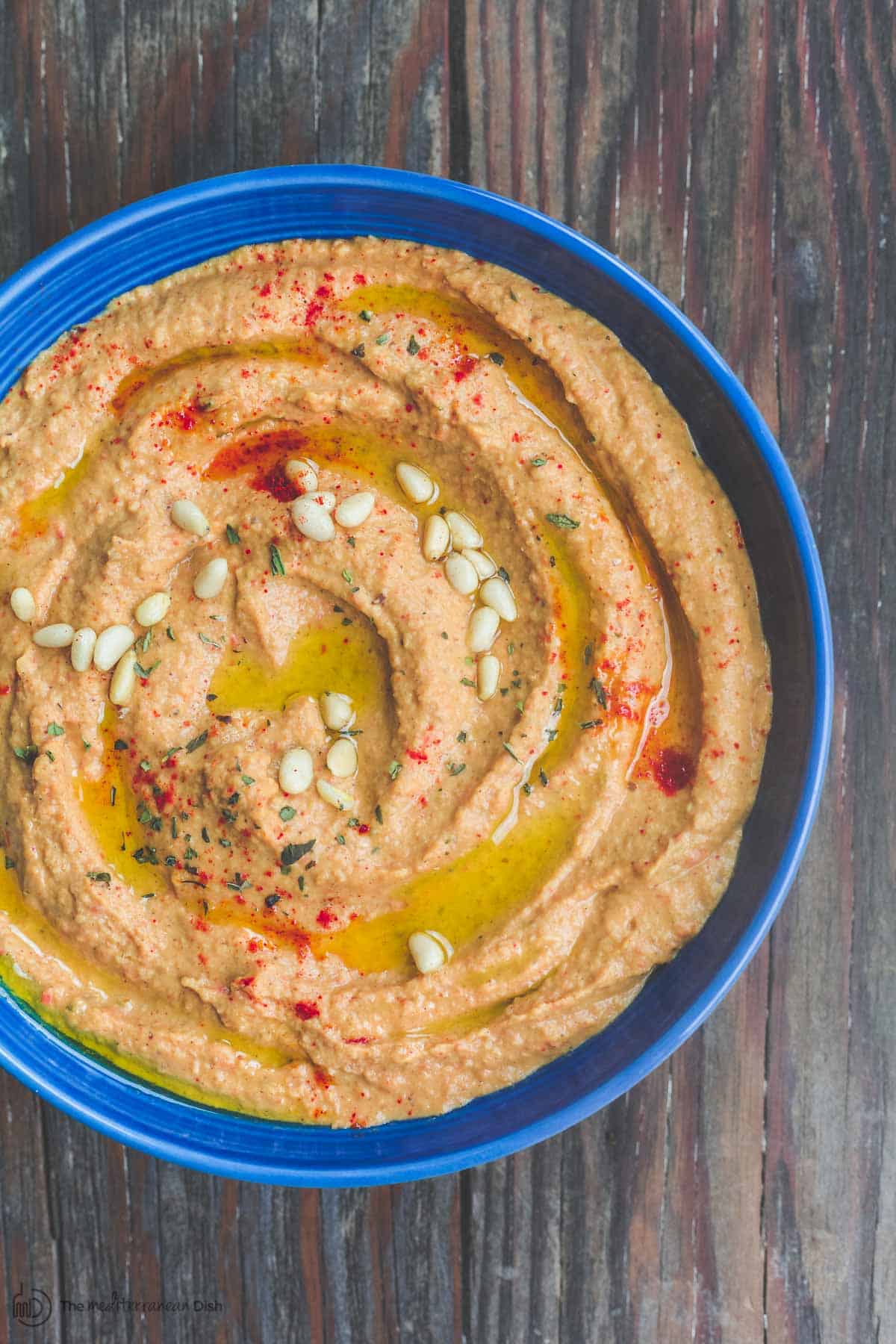 Roasted red pepper hummus with olive oil and pine nuts
