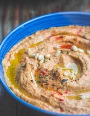 Roasted Red Pepper Hummus Recipe | The Mediterranean Dish. A rustic hummus dip with lots of punch! Roasted red peppers, jalapeno, garlic and a couple of great spices, blended to a make the best roasted red pepper hummus! Yes, THE BEST! Check out the recipe on TheMediterraneanDish.com