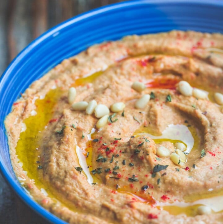 Roasted Red Pepper Hummus Recipe | The Mediterranean Dish. A rustic hummus dip with lots of punch! Roasted red peppers, jalapeno, garlic and a couple of great spices, blended to a make the best roasted red pepper hummus! Yes, THE BEST! Check out the recipe on TheMediterraneanDish.com