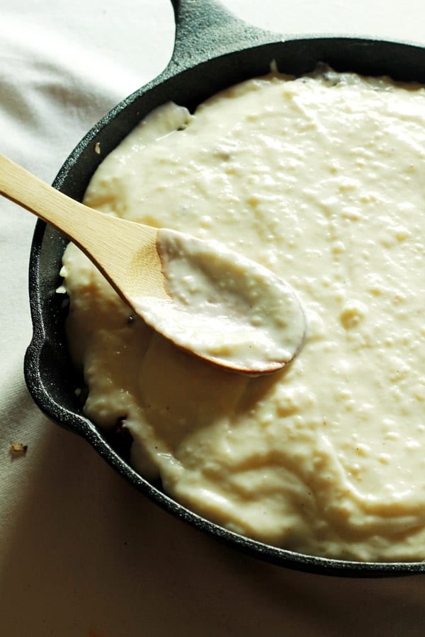 bechamel sauce evenly spread on top of Casserole 