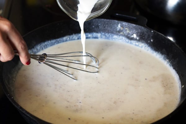 Milk added to skillet and whisked