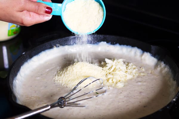 Grated Parmesan cheese added to skillet