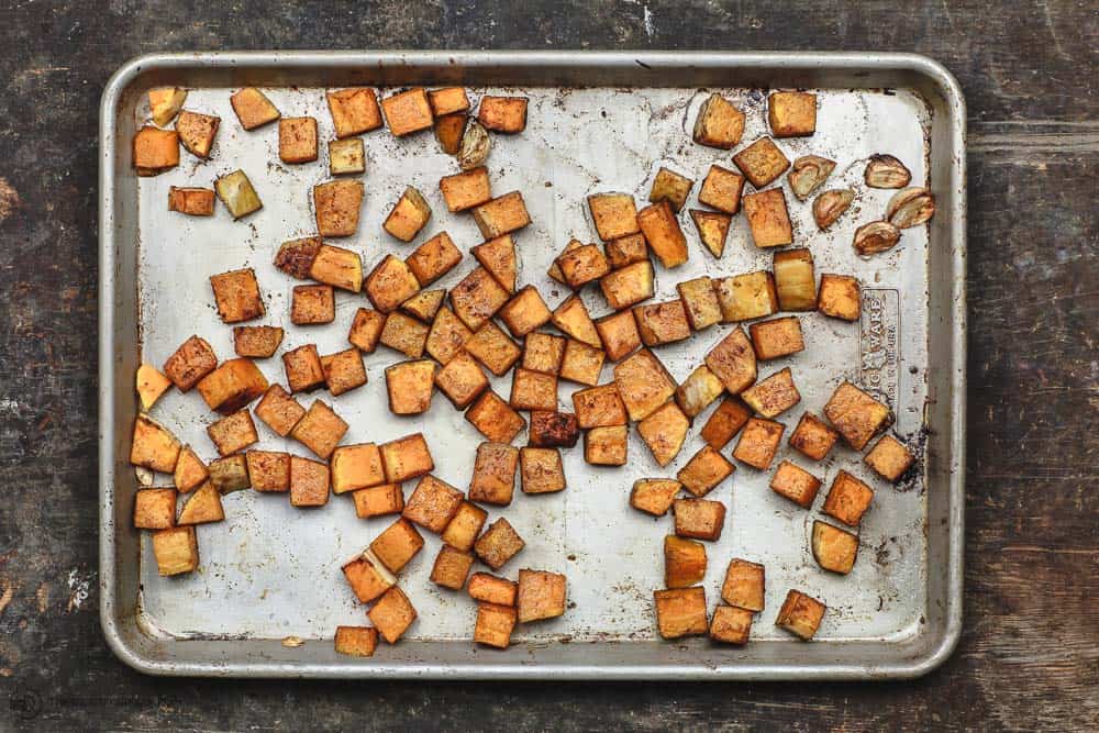 Butternut squash cubes, seasoned and roasted with olive oil and garlic cloves