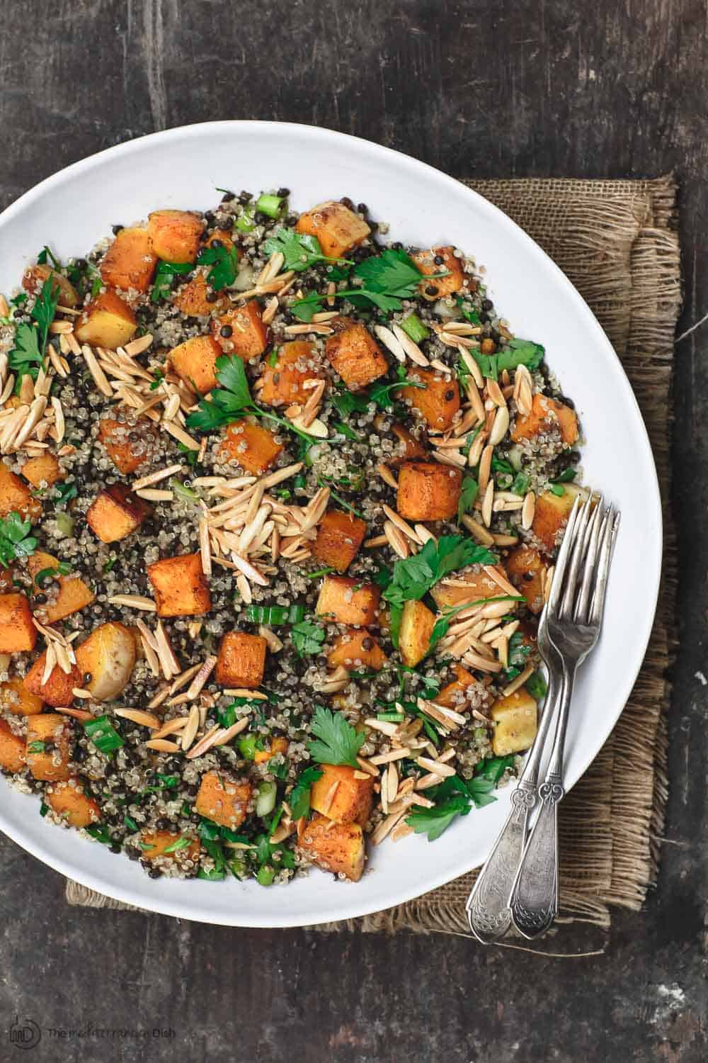 Easy Roasted Butternut Squash Recipe with Lentils and Quinoa. Seasoned with Mediterranean spices. Topped with toasted almond