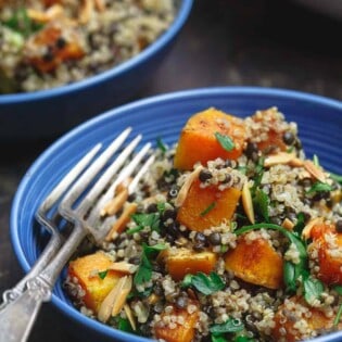 Close up side shot of Easy Roasted Butternut Squash with Lentils and Quinoa. Seasoned with Mediterranean spices and topped with toasted almonds