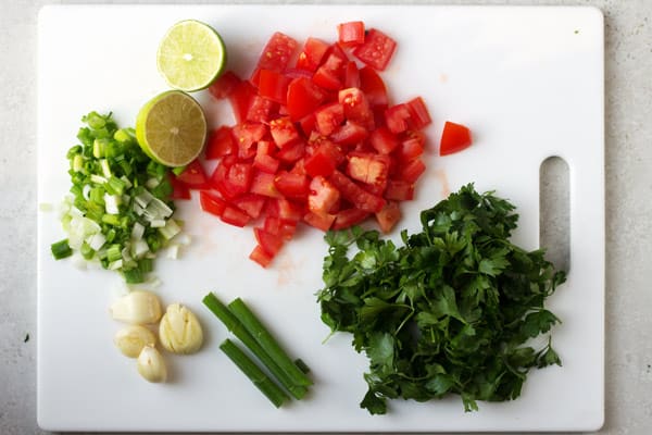 Ingredients of stew chopped up on a cutting board