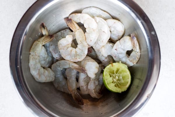 Raw shrimp in a bowl with lime juice