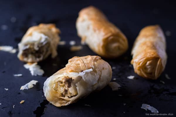 Baked meat rolls with one cut open showing filling