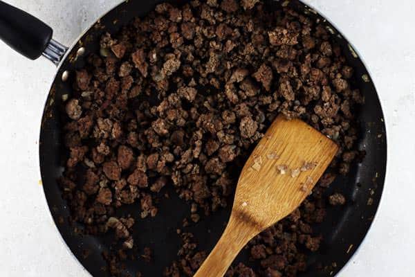 Beef being browned in a pan