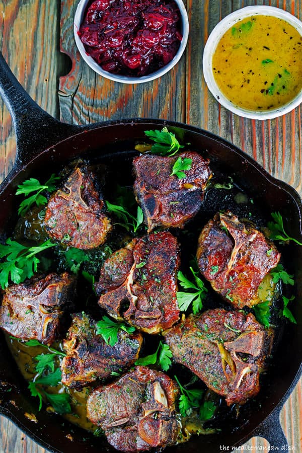 Lamb chops in skillet with cranberry chutney on side