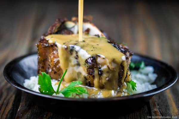 Lamb Chops served in a bowl over rice with Cranberry-Harissa Chutney