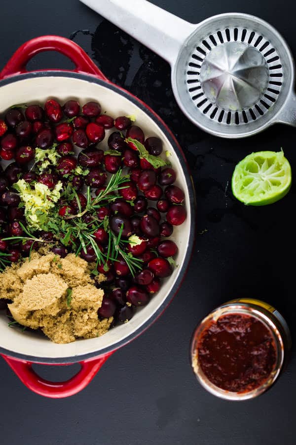 Cranberries, lime juice and brown sugar added to a bowl