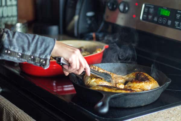 Seasoned chicken thighs fried in a skillet