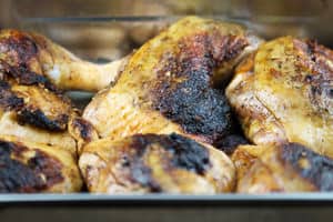 Pomegranate chicken thighs in baking pan