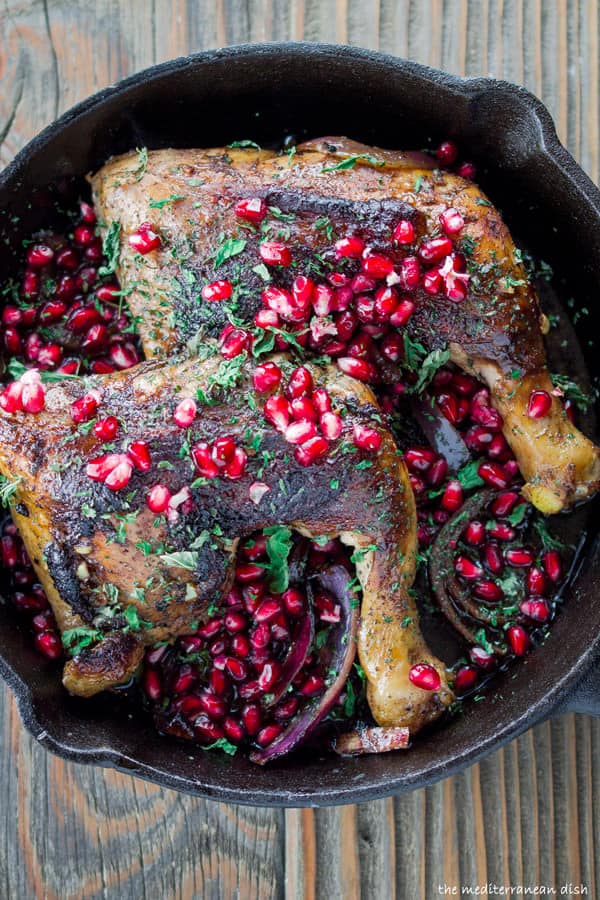 Mediterranean chicken thighs served with extra pomegranate seeds