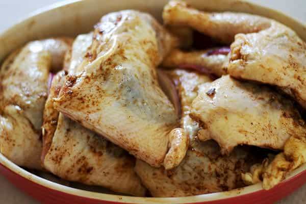 Seasoned chicken thighs added to a skillet