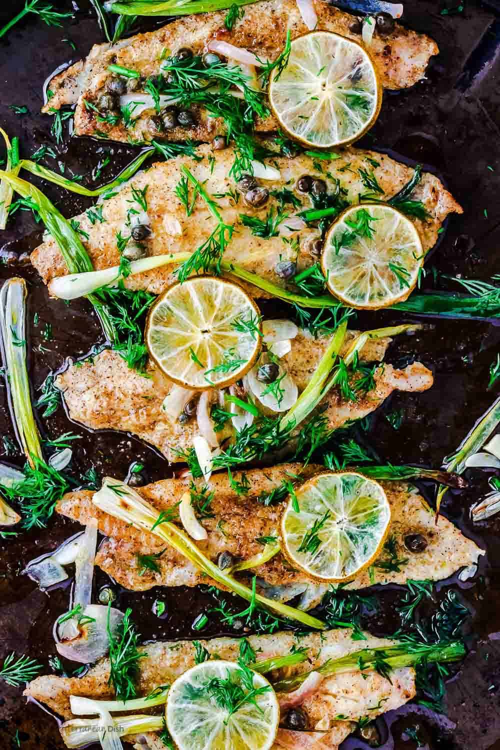 Baked sole garnished with capers and lemon slices