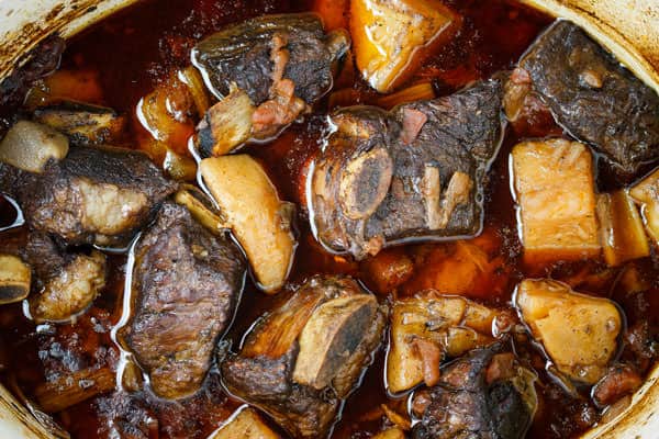 Beef and sauteed vegetables are added back to the pot