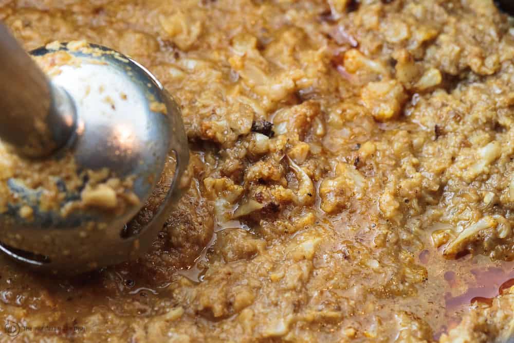 Using an immersion blender, blend cauliflower and liquid to form the creamy soup base