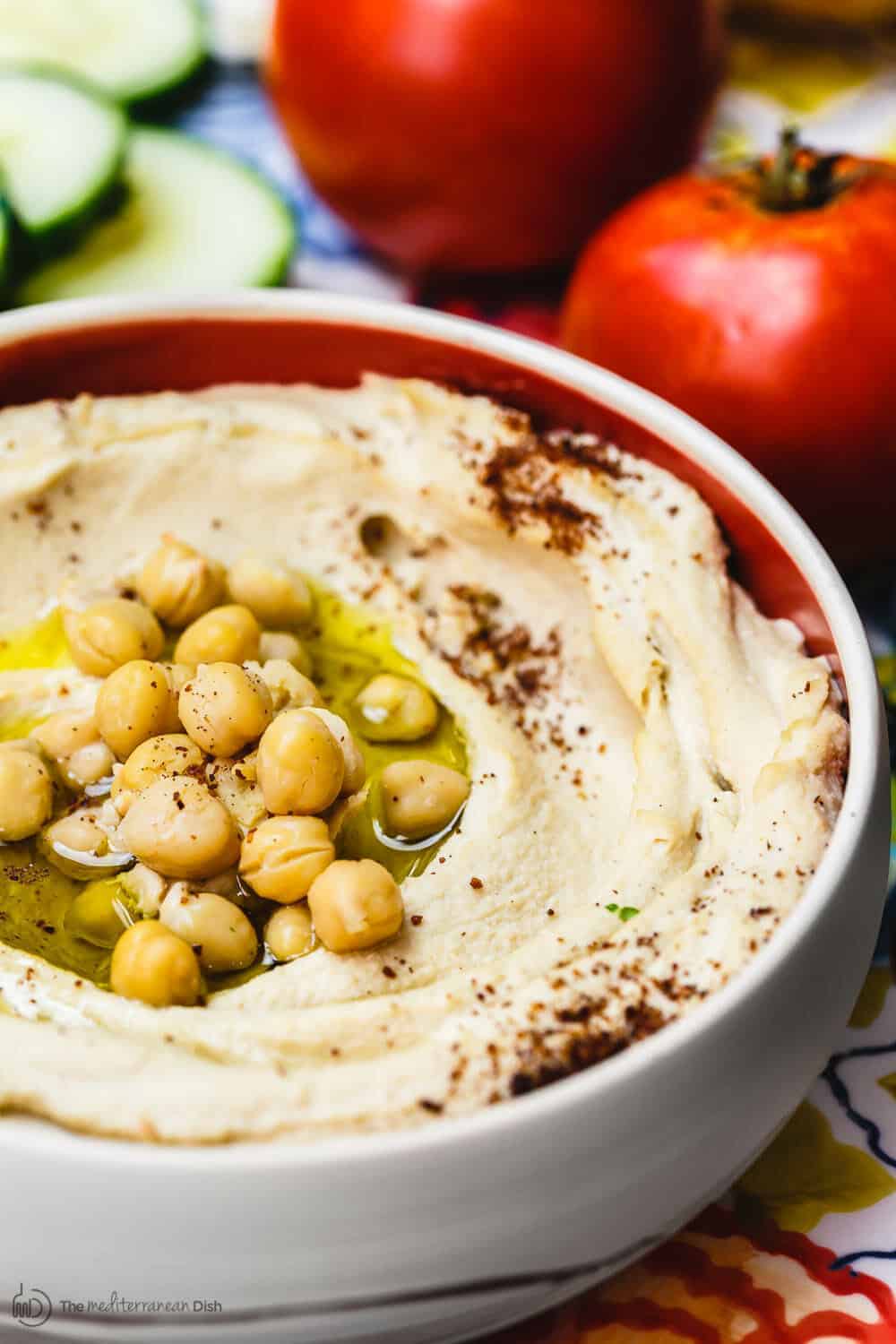 How to Make Hummus from Scratch | The Mediterranean Dish. BEST hummus recipe you will find! A few tricks and a video tutorial takes you through how to make the best, thick, smooth, rich, and ultra cream hummus you will find. Vegan. Gluten free. This hummus dip is a must try from TheMediterraneanDish.com #hummus #hummusrecipe #dip #hummusdip #veganrecipes #glutenfreerecipes #mediterraneandiet #mediterraneanrecipes #middleeasternrecipes