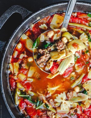 Italian Sausage Minestrone Recipe. The perfect weeknight meal! With chickpeas, artichoke hearts, green beans, fresh herbs like parsley and basil, and more! From The Mediterranean Dish