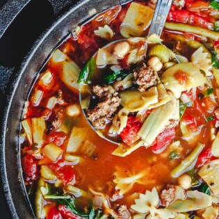 Italian Sausage Minestrone Recipe. The perfect weeknight meal! With chickpeas, artichoke hearts, green beans, fresh herbs like parsley and basil, and more! From The Mediterranean Dish