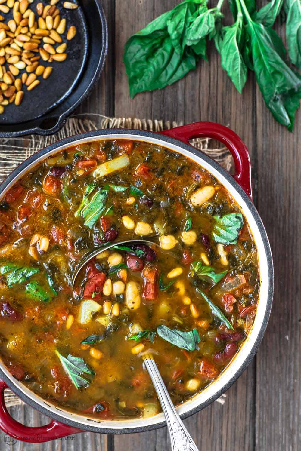 Mediterranean Bean Soup with Tomato Pesto | The Mediterranean Dish. Tons of flavor in this cozy bean soup loaded with vegetables, and Mediterranean flavors from spices and amazing fresh tomato pesto. This is not your average bean soup! A must try from TheMediterraneanDish.com #beansoup #mediterraneandiet #mediterraneanfood #mediterraneanrecipes #vegetablesoup #vegetarian #glutenfree #budgetfriendly #onepot #chickpeas #kidneybeans #beans #soup