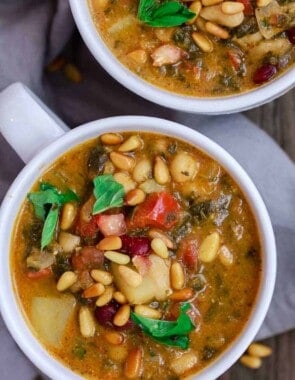 Mediterranean Bean Soup with Tomato Pesto | The Mediterranean Dish. Tons of flavor in this cozy bean soup loaded with vegetables, and Mediterranean flavors from spices and amazing fresh tomato pesto. This is not your average bean soup! A must try from TheMediterraneanDish.com #beansoup #mediterraneandiet #mediterraneanfood #mediterraneanrecipes #vegetablesoup #vegetarian #glutenfree #budgetfriendly #onepot #chickpeas #kidneybeans #beans #soup