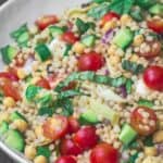 Mediterranean pearl couscous salad served in large bowl