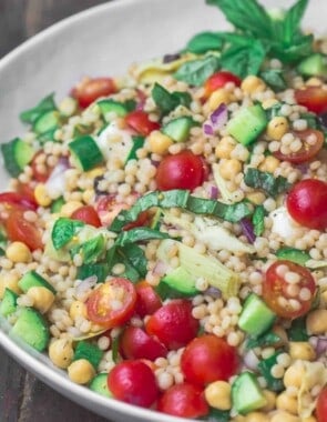 Mediterranean pearl couscous salad served in large bowl