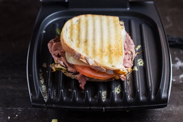 Place the second piece of bread on top and close the table-top grill to toast second piece of bread