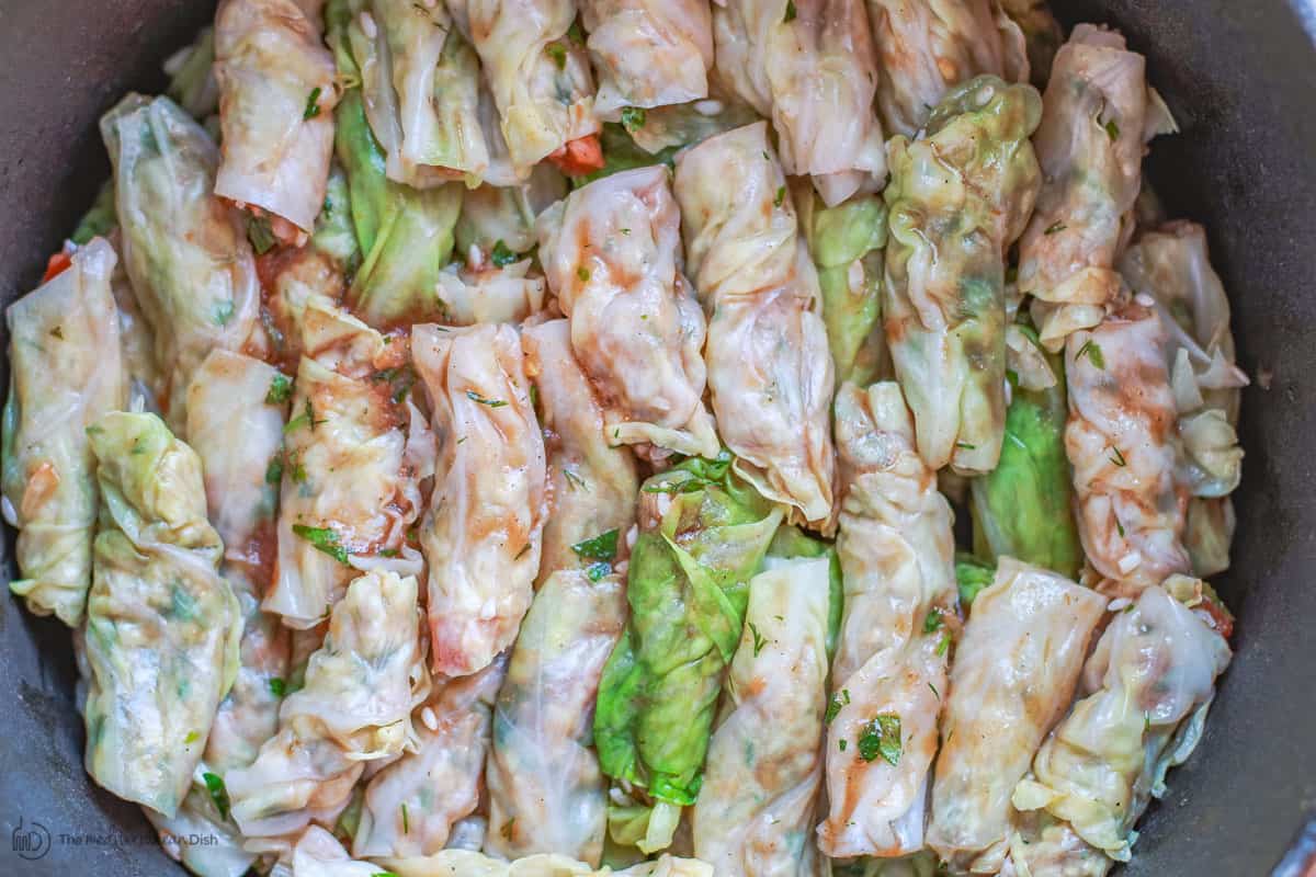 Vegetarian stuffed cabbage rolls layered in large pot