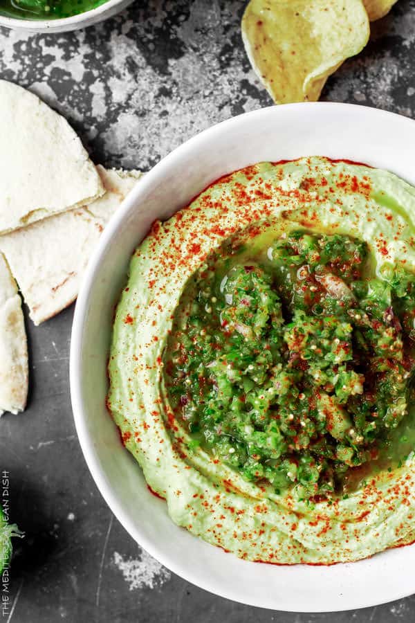 Avocado Hummus with Fresh Tomattillo Salsa Verde from The Mediterranean Dish! Super creamy avocado hummus topped with flavor packed fresh tomattillo salsa verde. Two amazing appetizer recipes combined! Step-by-step pictures included!