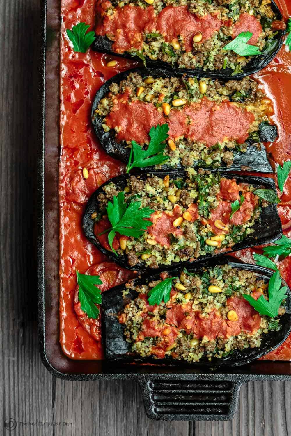 Mediterranean Stuffed Eggplant Recipe | The Mediterranean Dish. This is a must-try all star recipe for stuffed eggplants. Roasted eggplants stuffed with a fragrant spiced meat, bulgur and pine nut mixture. So good! See full recipe on TheMediterraneanDish.com