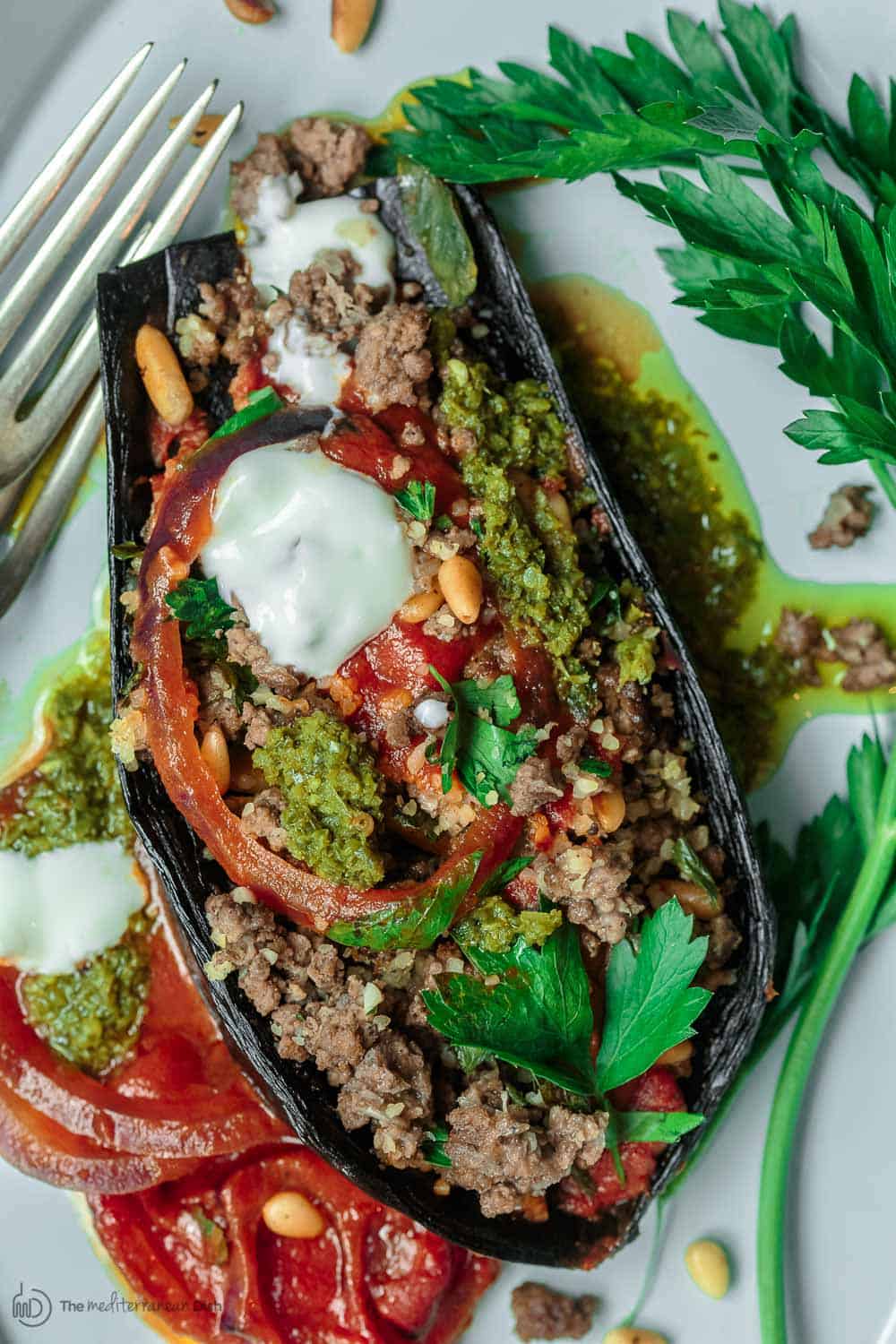 Mediterranean Stuffed Eggplant Recipe | The Mediterranean Dish. This is a must-try all star recipe for stuffed eggplants. Roasted eggplants stuffed with a fragrant spiced meat, bulgur and pine nut mixture. So good! See full recipe on TheMediterraneanDish.com