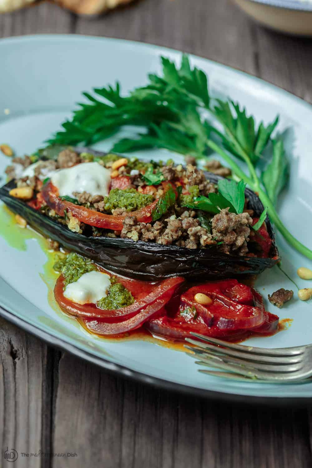 Mediterranean Stuffed Eggplant Recipe | The Mediterranean Dish. This is a must-try all star recipe for stuffed eggplants. Roasted eggplants stuffed with a fragrant spiced meat, bulgur and pine nut mixture. So good! See full recipe on TheMediterraneanDish.com