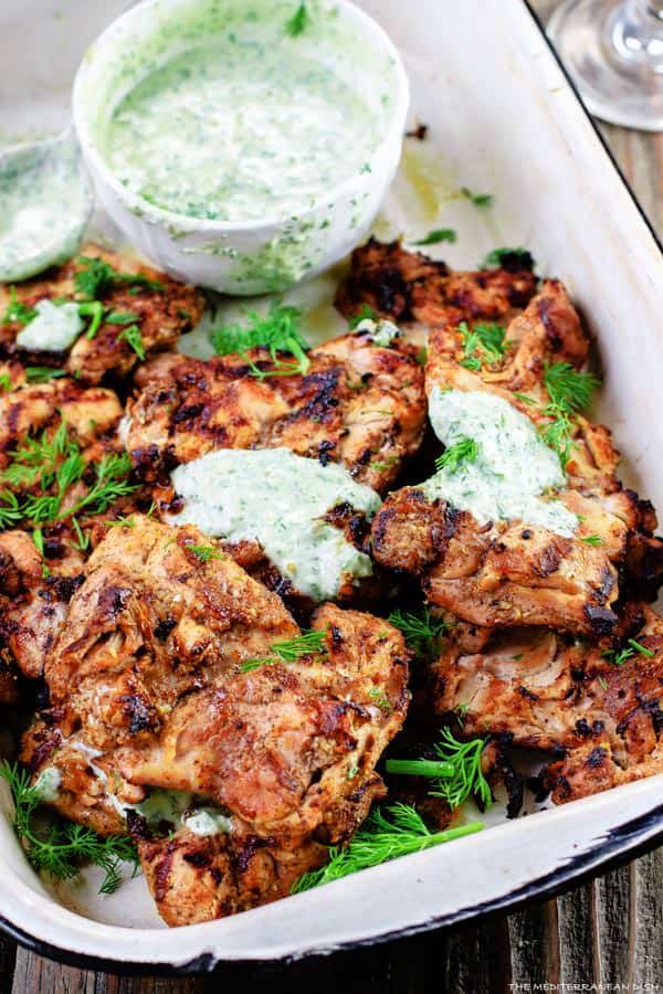 Mediterranean Grilled Chicken + Dill Greek Yogurt Sauce. Top grill recipe! Marinate boneless chicken thighs in Mediterranean spices, olive oil and lemon juice. Grill for less than 15 minutes, and serve with this flavor-packed dill yogurt sauce! Pin it to try soon!