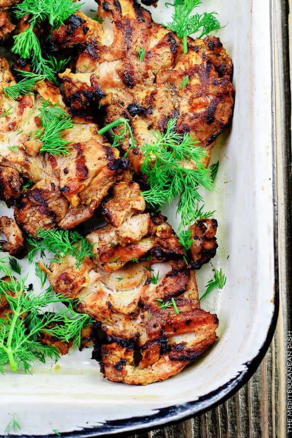 Mediterranean Grilled Chicken + Dill Greek Yogurt Sauce. Top grill recipe! Marinate boneless chicken thighs in Mediterranean spices, olive oil and lemon juice. Grill for less than 15 minutes, and serve with this flavor-packed dill yogurt sauce! Pin it to try soon!