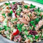 Mediterranean Tuna Salad with fresh herbs, chopped vegetables and Dijon vinaigrette on a plate