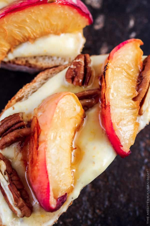 Peaches and pecans on top of crostini with yogurt