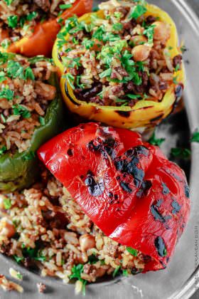 Mediterranean Stuffed Peppers Recipe | The Mediterranean Dish. Easy, delicious, stuffed peppers recipe with step-by-step tutorial. The gluten free Mediterranean-style stuffing with rice, chickpeas and spiced ground beef is a favorite! See the full recipe on TheMediterraneanDish.com